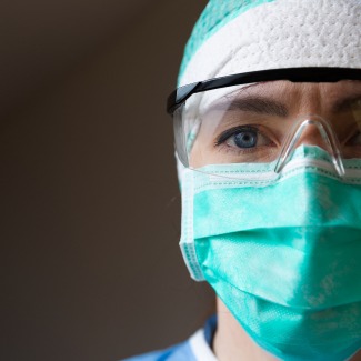 nurse in PPE looking at camera